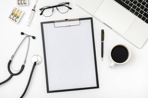 Workplace of modern doctor with laptop and stethoscope on white table. Top view. Flat lay