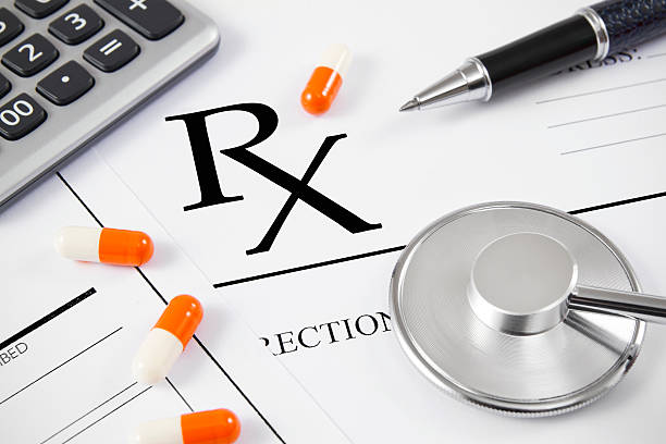 Close-up of RX prescription and stethoscope with patient forms.