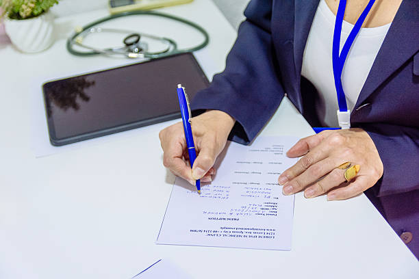 Doctor's hands writing notes and medical prescriptions for patient, embodying the concepts of healthcare, treatment, medicine, and professional medical practice