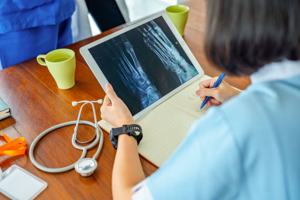 medical staff using digital tablet looking on x-ray at medical clinic